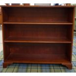 MAHOGANY OPEN BOOKCASE with fitted shelving, raised on bracket feet, 86cm high x 96cm wide