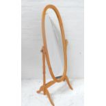 OVAL BEECH CHEVAL MIRROR supported by turned arms and standing on splayed supports, 155cm high
