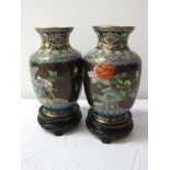 PAIR OF CHINESE CLOISONNE VASES with a black ground decorated with birds of paradise and flowers, on