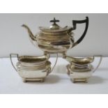 GEORGE V SILVER TEA SET comprising a tea pot, twin handled sugar bowl and milk jug, all raised on