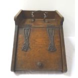 ARTS AND CRAFTS OAK COAL SCUTTLE with a shaped metal handle encased by a three quarter pierced