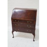 WALNUT BUREAU with a figured walnut fall front opening to reveal a fitted interior with three