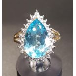 BLUE TOPAZ AND DIAMOND DRESS RING the pear cut topaz in illusion setting with four small diamonds,