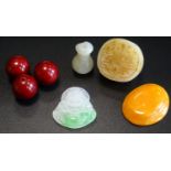 SMALL SELECTION OF JADE AND AMBER comprising three cherry amber beads, a jade seal, a small carved