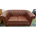 CHESTERFIELD TWO SEAT SOFA in brown leather with a button back and arms with decorative stud detail,