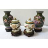 PAIR OF CHINESE CLOISONNE VASES with a dark green ground decorated with a basket of flowers, on a