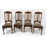 SET OF FOUR OAK ARTS AND CRAFTS DINING CHAIRS with shaped carved top rails above shaped and carved
