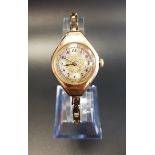 LADIES ROLEX FIFTEEN CARAT GOLD WRISTWATCH circa 1920s, the dial with engraved floral decoration