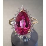 PINK TOPAZ AND DIAMOND DRESS RING the large pear cut topaz in illusion setting with four small