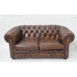 CHESTERFIELD TWO SEAT SOFA in brown leather with a button back and arms with decorative stud detail,