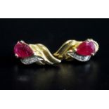 PAIR OF RUBY AND DIAMOND EARRINGS in attractive wavy nine carat gold setting