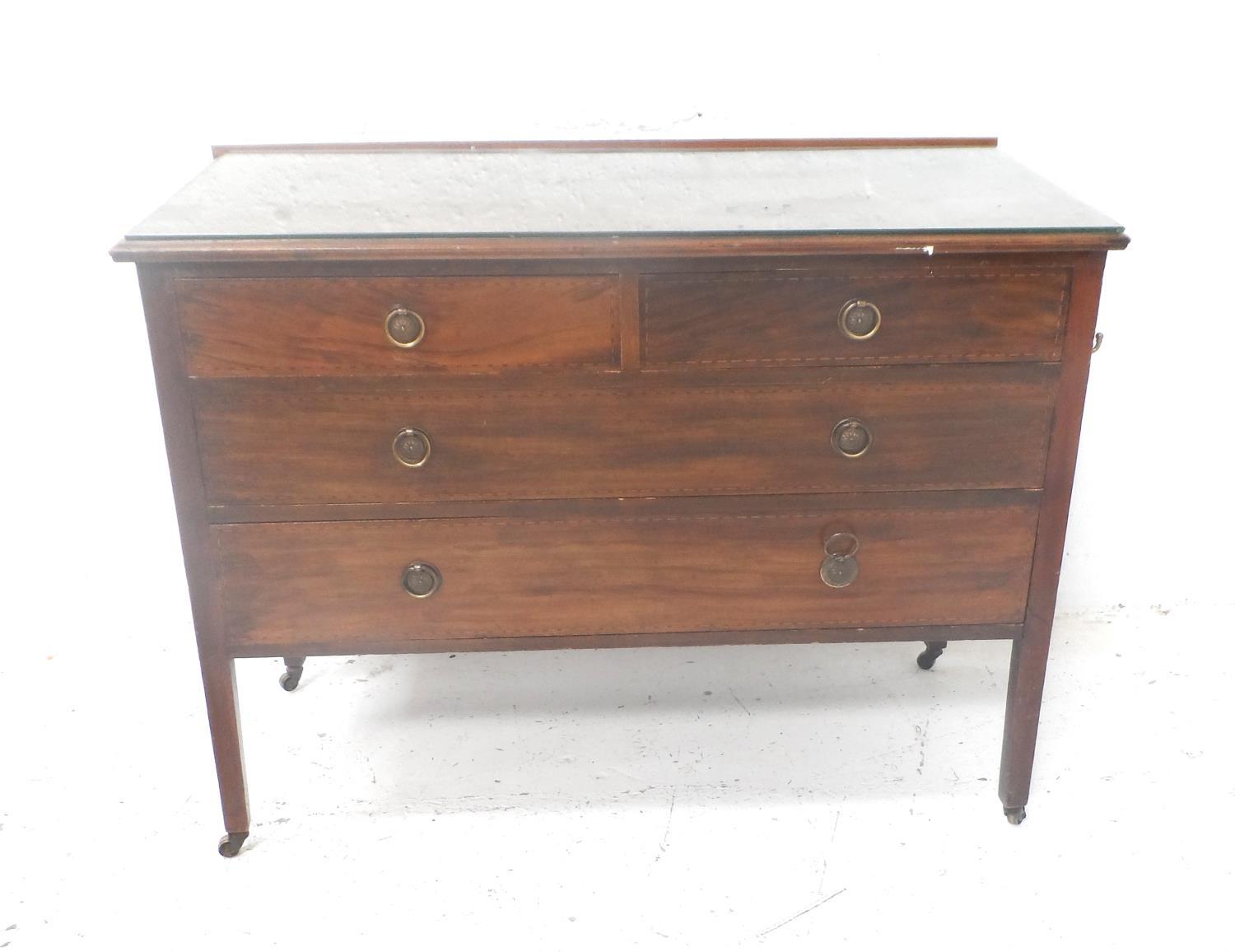 EDWARDIAN MAHOGANY AND INLAID CHEST with two short and two long drawers, standing on plain