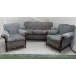 1950'S THREE SEAT SOFA with a shaped back with scroll arms and a mahogany carved frame, standing