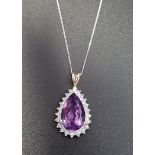 AMETHYST AND DIAMOND DROP PENDANT the central pear cut amethyst within illusion setting with four