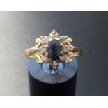 SAPPHIRE AND DIAMOND CLUSTER RING the central oval cut sapphire in diamond surround, on nine carat