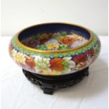 CHINESE CLOISONNE CENTRE BOWL decorated with colourfull flowers on a circular hardwood stand, 23cm