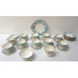 PARAGON TEA SERVICE the pale blue and white ground decorated with flowers and signed to the