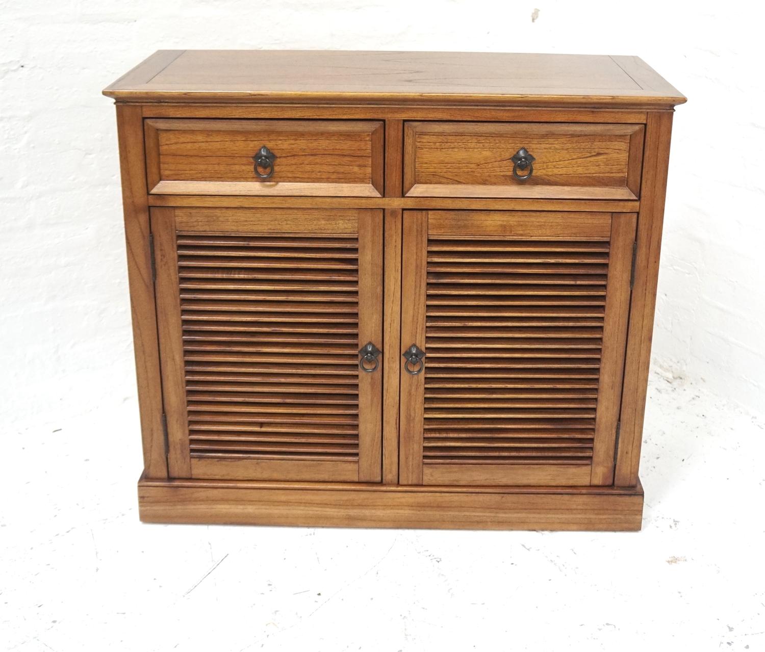 TEAK SIDE CABINET with a crossbanded moulded top above two frieze drawers with a pair of slatted