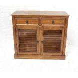 TEAK SIDE CABINET with a crossbanded moulded top above two frieze drawers with a pair of slatted