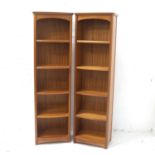PAIR OF NATHAN TEAK BOOKCASES each with a moulded top above four shelves, 183.5cm x 54cm (2)
