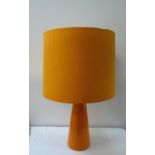1970'S MICHAEL ANDERSON POTTERY TABLE LAMP of conical form in orange, with an orange circular
