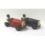 TWO VINTAGE STYLE RACE CARS each with open tops with a driver, one red and one blue, in pottery,