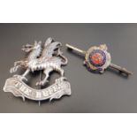 UNMARKED SILVER 'BUFFS' DRAGON BROOCH the dragon standing on a ribbon marked 'The Buffs'; together