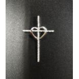 DIAMOND SET CROSS PENDANT in unmarked nine carat white gold, the centre of the cross with heart