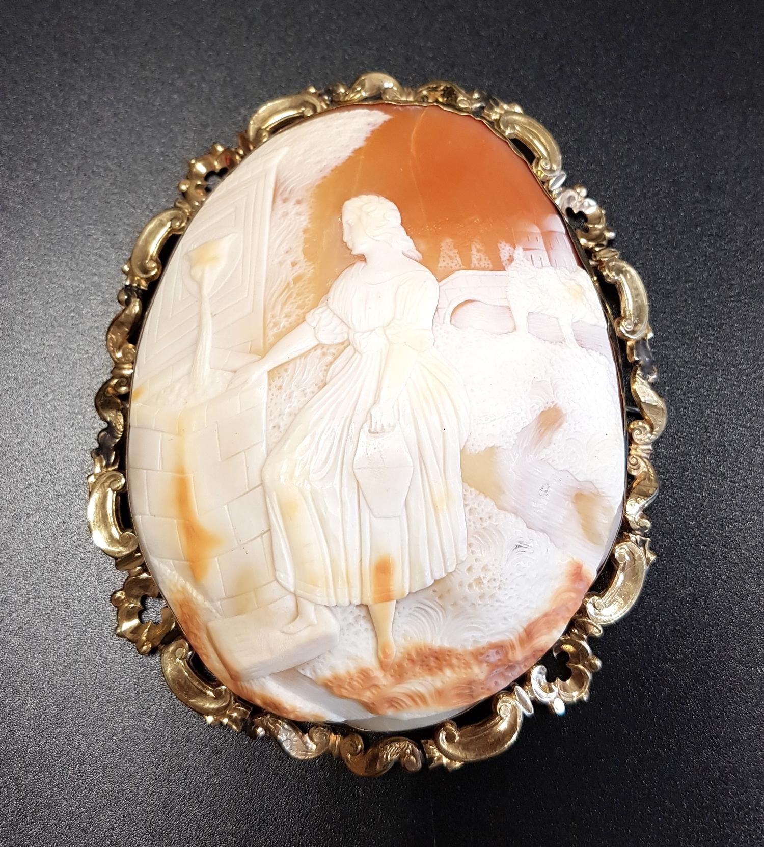 VERY LARGE SHELL CAMEO BROOCH depicting a maiden at a well with coutryside and houses in the