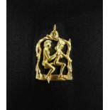 UNUSUAL EROTIC NINE CARAT GOLD PENDANT the male figure with articulated body seated behind the