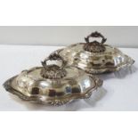 PAIR OF LATE VICTORIAN SILVER PLATED SERVING DISHES of shaped outline, the lids with ornate