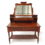 MAPLE & CO. EDWARDIAN MAHOGANY DRESSING TABLE with a shaped bevelled mirror above two central