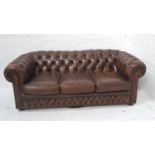 CHESTERFIELD THREE SEAT SOFA in brown leather with a button back and arms with decorative stud