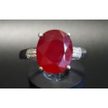 RUBY AND DIAMOND RING the central oval cut ruby approximately 3.5cts flanked by six small diamonds