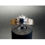 SAPPHIRE AND DIAMOND CLUSTER RING the central round cut sapphire approximately 0.2cts in illusion
