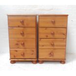PAIR OF PINE BEDSIDE CHESTS with moulded tops above four drawers with turned handles, standing on