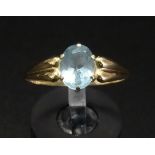 OVAL CUT AQUAMARINE SINGLE STONE RING on fourteen carat gold shank with shaped shoulders, ring