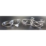 FIVE SILVER BANGLES including one of wide lattice design, another with decorative twist centre,