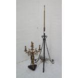 WROUGHT IRON STANDARD LAMP with an extending brass pole, raised on three outswept scroll supports,