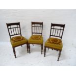 SET OF SIX EDWARDIAN MAHOGANY DINING CHAIRS each with a carved top rail and spindle back above a