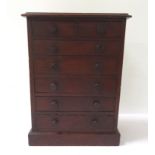 AN APPRENTICE MAHOGANY CHEST with a moulded top above two short and five long drawers with turned