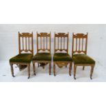 SET OF FOUR EDWARDIAN OAK DINING CHAIRS each with a shaped carved top rail above a stuffover seat,