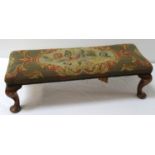 MAHOGANY FRAME FOOTSTOOL of oblong form with a gros point floral decorated top, standing on stout