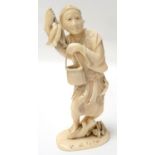 CHINESE CARVED IVORY FISHERMAN standing on a tree stump with fish beside him, and holding three fish