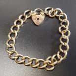 NINE CARAT GOLD CURB LINK BRACELET with nine carat gold padlock clasp, approximately 19.3 grams