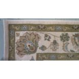 GOOCH WOBURN WOOL RUG the mushroom coloured ground decorated with floral motifs and encased by a