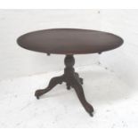 OAK TILT TOP TABLE with an oval top on a turned column with three outswept supports with porcelain