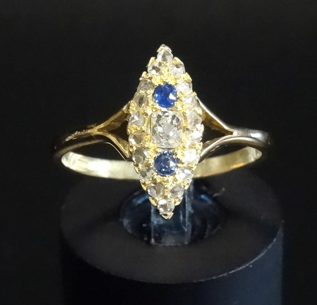 VICTORIAN SAPPHIRE AND DIAMOND CLUSTER DRESS RING in navette shaped setting, the central diamond