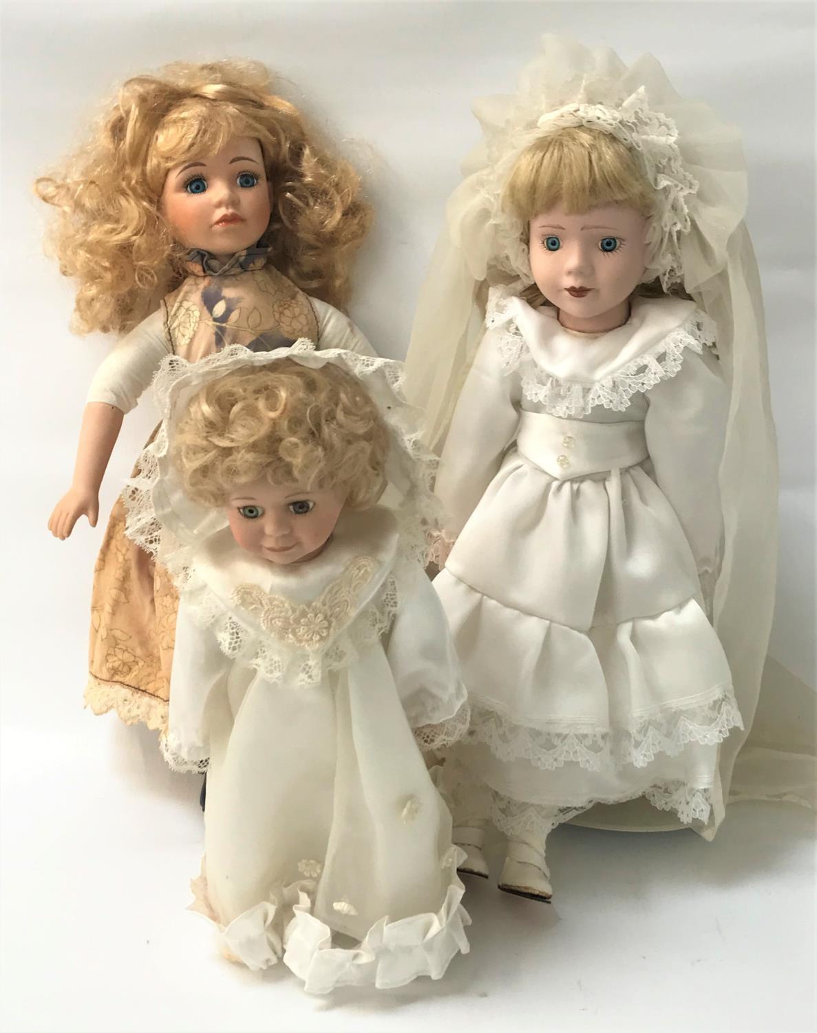 THREE BISQUE HEAD DOLLS, one marked Reginy 451, the other two on stands (3)