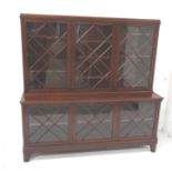 MAHOGANY LIBRARY BOOKCASE with a moulded top above three lattice glazed doors flanked by canted